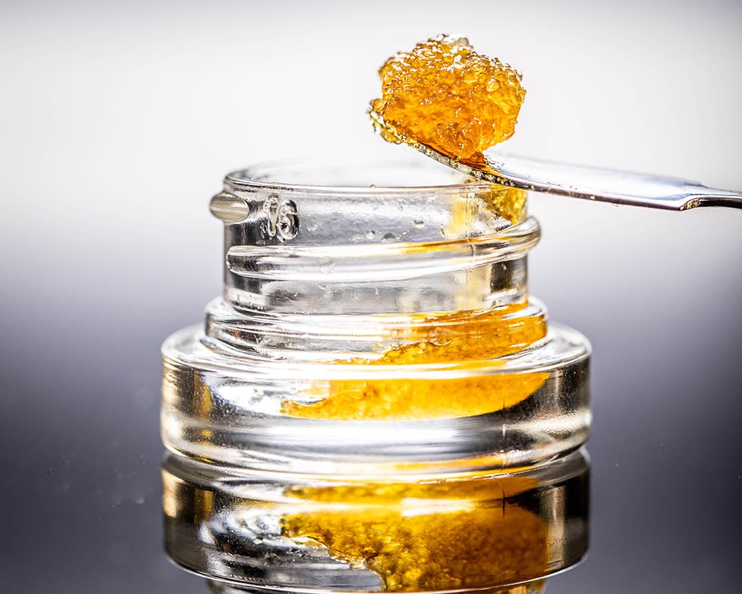 Live Resin Dab Sauce Cannabis Oil Macro with Jar Isolated Legal California Extracts from Weed Dispensary - Shutterstock