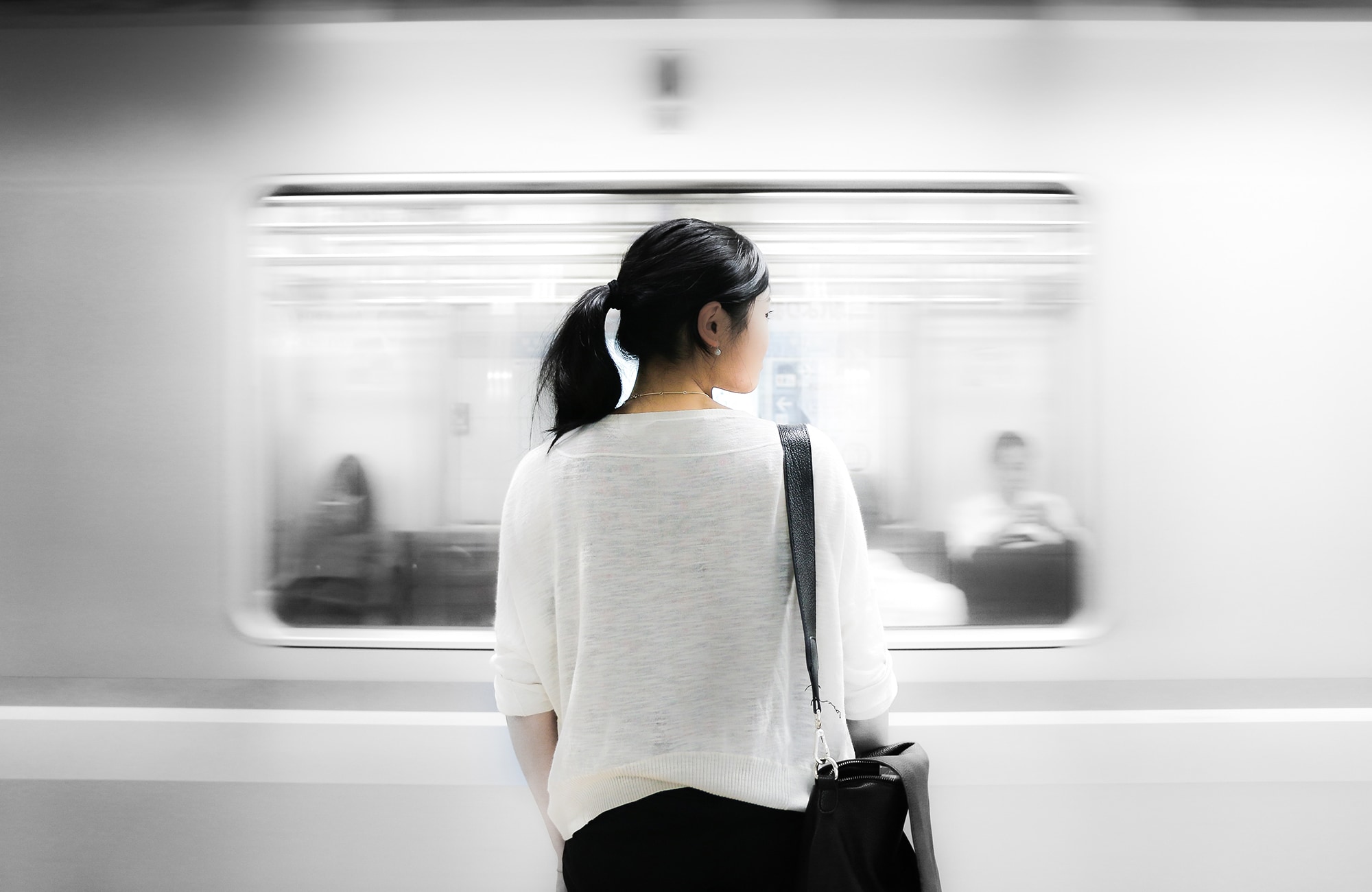 Woman in front of moving train