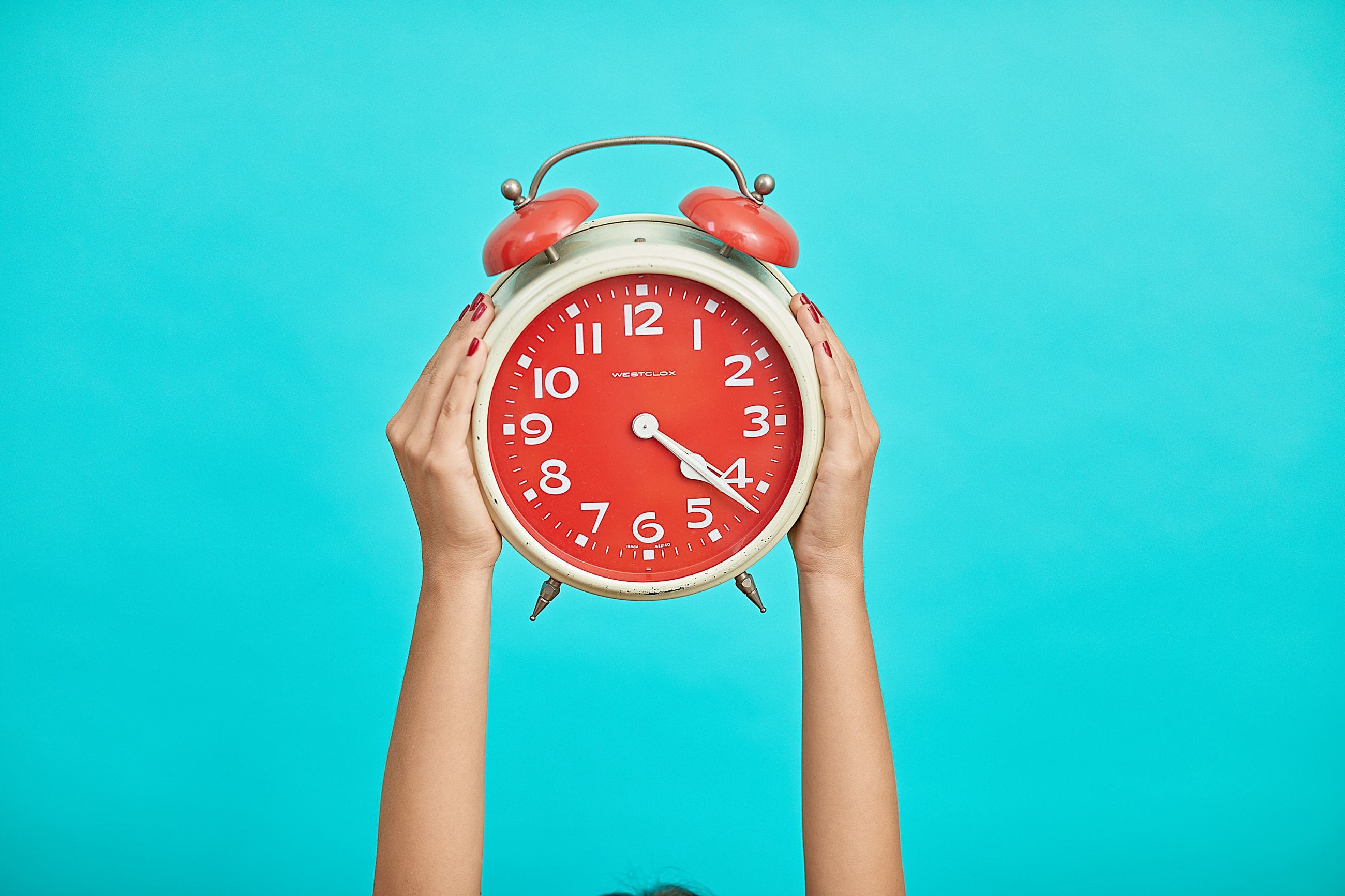 A person holding a clock