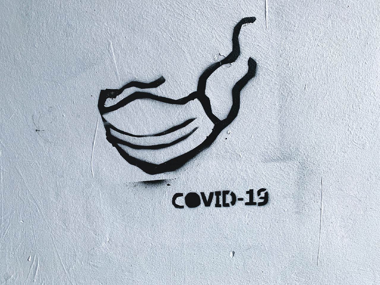 Photo of graffiti of person wearing Covid 19 mask