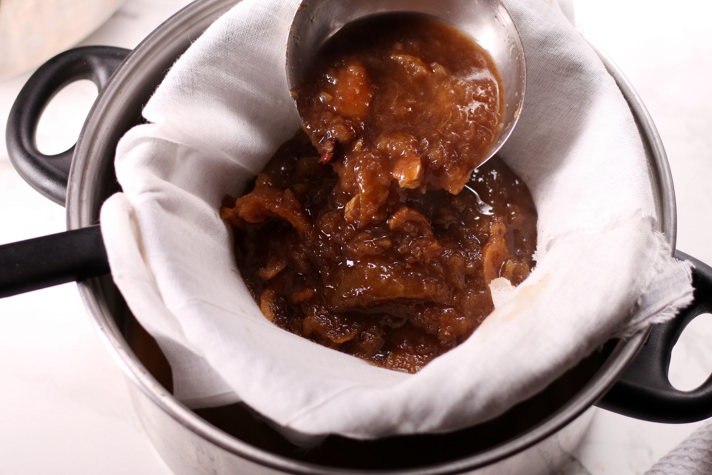 Straining the fruit and spices