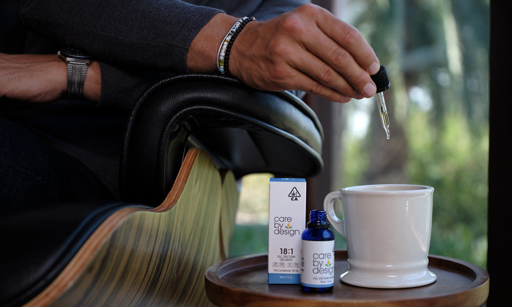 A man adding CBD to a coffee mug